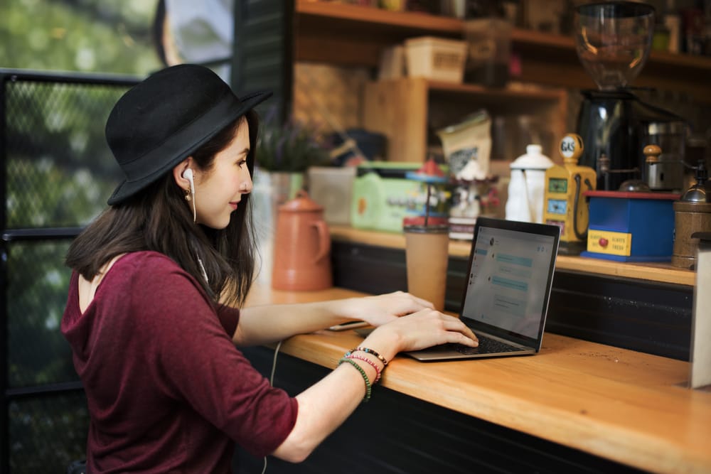 Digital nomad working on a laptop and phone while travelling