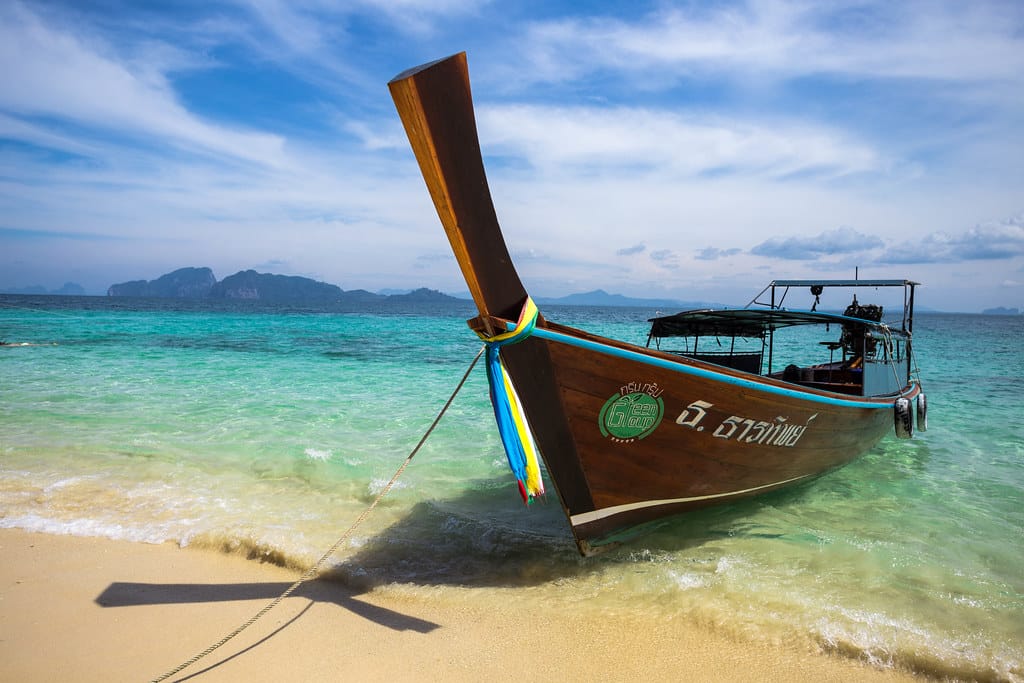 Longtail boats on a tropical Thailand beach, one of the Visa Destinations countries
